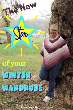 a woman leaning against a tree wearing a knitted ponchy with the words, the new star of your winter wardrobe