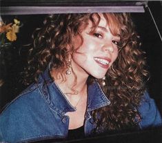 a close up of a person wearing a jean jacket