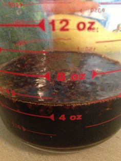 a measuring cup filled with liquid on top of a counter