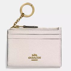 Coach Mini Skinny Id Case Met In Packaging Style Number 88250 Measurements Length: 4.25" Height: 3.0" Width: 0.5" Materials Crossgrain Leather Fabric Lining Features Two Credit Card Slots Zip-Top Closure Attached Split Key Ring Id Window Elegant Gold Coach Coin Purse, Everyday Beige Bag With Coin Pocket, Chic Coach Coin Purse With Card Slots, Coach Bags With Card Slots For Gift, Coach Bags With Card Slots For Travel, Classic Gold Bag With Card Slots, Coach Travel Bag With Card Slots, Classic Gold Bags With Card Slots, Coach Rectangular Bag With Interior Key Chain Holder