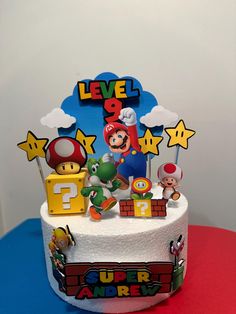 there is a cake with mario and other toys on it