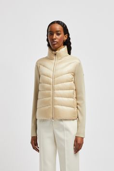 A classic Moncler design, this padded cardigan can easily be worn alone or layered under coats and jackets. Crafted from the softest wool, the lightweight knit is enhanced with a down-filled front and back. Fitted Luxury Beige Cardigan, Luxury Fitted Beige Cardigan, Luxury Beige Cardigan, Classic Beige Merino Wool Outerwear, Fitted Beige Merino Wool Outerwear, Luxury Outerwear For Winter Layering, Cream Merino Wool Winter Outerwear, Cream Merino Wool Outerwear For Winter, Cardigan Beige