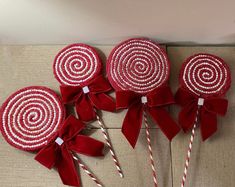 red and white lollipops are sitting on a table with candy canes