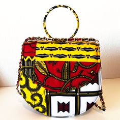 This gorgeous ZAI Handbag is perfect for travel, work, or parties. Our light bag is sourced from Ghana and made of Authentic 100% African print fabric with stitch details for a luxe look and, chain that can be carried as single or double. The Interior accessory and pockets help you keep items organized in your purse. This bag is individually handcrafted and lovingly made to be unique to you Description: African Print handbag The inner is fully lined with black fabric Interior compartments for or Rectangular Box Bag With Chain Strap For Travel, Travel Bag With Chain Strap And Top Handle, Yellow Pouch Box Bag For Travel, Rectangular Bags With Chain Strap For On-the-go, Travel Pouch Box Bag With Chain Strap, Travel Box Bag With Chain Strap And Pouch Shape, Yellow Bag With Chain Strap For Everyday Use, Yellow Bags With Chain Strap For Everyday Use, Trendy Clutch Box Bag For Travel