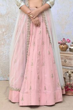 Pink spun silk lehenga with sequins embroidery. Comes with a powder blue raw silk blouse and a net jacket.
Components: 3
Pattern: Embroidered
Type Of Work: Sequins
Neckline: Round
Sleeve Type: Jacket : Full, Blouse : Sleeveless
Fabric: Lehenga : Spun silk, Blouse : Raw silk, Jacket : Net
Color: Pink
Other Details: 
Lehenga length : 44 inches
Closure : Blouse - Back hooks and potli buttons with loop detailing
Occasion: Destination Wedding - Aza Fashions Raw Silk Sets With Sheer Dupatta, Transitional Palazzo Set For Reception, Reception Long Skirt Sharara With Dupatta, Zari Work Anarkali Set For Reception With Long Skirt, Reception Anarkali Set With Zari Work And Long Skirt, Raw Silk Choli For Wedding, Silk Gown With Dori Work, Cutdana Lehenga With Traditional Drape, Resham Embroidered Choli With Long Skirt