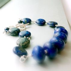 This lapis lazuli bracelet handcrafted by Jewelry By Carmal is made of navy blue lapis lazuli rondelle and disk gemstones, sterling silver: crown charm, toggle and findings. This bracelet measures up to 7 3/4 inches in length. View more beaded bracelets: http://www.etsy.com/shop/jewelrybycarmal?section_id=8002918 The ancient Romans used lapis as an aphrodisiac. Lapis lazuli is said to help stimulate emotional, mental, and physical purity and clarity. The ancient Egyptians used lapis for protecti Everyday Blue Beaded Bracelet With Natural Stones, Everyday Blue Gemstone Beads Jewelry, Blue Beaded Bracelets With Stones, Blue Gemstone Beads Bracelet For Everyday, Everyday Lapis Lazuli Jewelry With Gemstone Beads, Handmade Lapis Lazuli Jewelry For Everyday, Everyday Blue Gemstone Beads Bracelets, Artisan Blue Gemstone Beaded Bracelets, Blue Gemstone Bracelets For Everyday Wear