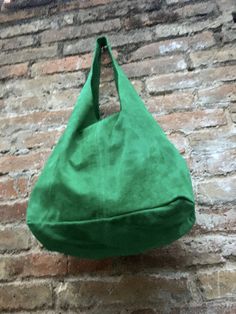 LARGE slouch leather bag in GREEN . Leather tote bag. Natural genuine SUEDE leather. NOT LINED. We added a small leather zipper pouch for your mobile phone and/or cards or money. It ist attached to the inside of the bag by a metal chain. This listing is for the bag in bright GREEN , there is a separate listing in our shop for moss green and also for the dark green bag on the last picture with the model. The bag is closed by a metal clip at the center. Width : 42cm - 16,5 in Height at the center: Suede Hobo Satchel Bag For Shopping, Suede Hobo Travel Bag, Green Bucket Shoulder Bag With Leather Handles, Green Leather Handle Bucket Shoulder Bag, Suede Hobo Bag With Leather Handles For Shopping, Soft Suede Hobo Bag For Shopping, Green Soft Leather Rectangular Bucket Bag, Suede Hobo Tote Bag With Large Capacity, Suede Lined Hobo Shoulder Bag For Shopping