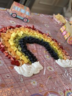 a cake shaped like a rainbow on top of a table