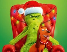 the grinch and his dog are sitting in a chair with christmas lights on them