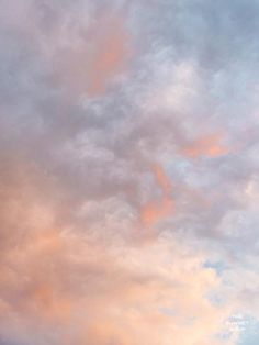 an airplane is flying in the sky at sunset