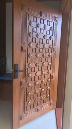 a wooden door with metal knobs on the front and side doors are made from wood