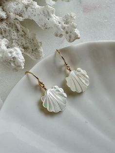 Welcome to SeashellandStoneco These adorable earrings feature Mother of Pearl shells, bringing a touch of the ocean to your style. The delicate shell design adds a lovely, natural shimmer that's perfect for any occasion. Lightweight and easy to wear, they're a sweet to brighten up your day! MATERIAL 14K Gold-Filled Jewelry Ball End Ear Wire   Size : 11.5 × 20mm Mother of Pearl Charm Size : 13 × 12mm AROUT 14K GOLD-FILLED JEWELRY 14K gold-filled jewelry contains 5% solid gold. The gold layer is p Elegant Shell-shaped Summer Jewelry, Elegant Summer Shell-shaped Jewelry, Elegant Shell Dangle Earrings, Elegant Dangle Shell Earrings, Elegant Dangle Shell, Elegant Shell Drop Earrings, Elegant Nickel-free Shell Jewelry, Elegant Hypoallergenic Earrings For Beach, White Shell-shaped Mother Of Pearl Earrings