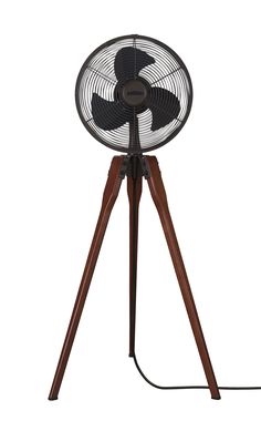 a black fan sitting on top of a wooden tripod