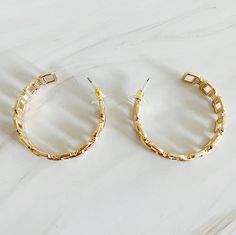 These Linked Golden Hoop Earrings offer a modern and chic twist on traditional hoop earrings. The unique linked design adds a touch of sophistication to any outfit. Elevate your style with these beautifully crafted earrings. Plated alloy metal Lead and Nickel compliant Made in China Trendy Hoop Earrings With Chain Detail, Modern Small Hoop Metal Earrings, Elegant Small Hoop Chain Earrings, Elegant Small Hoop Earrings With Chain Detail, Modern Hoop Earrings With Chain Detail, Chic Metal Hoop Earrings, Modern Chain Hoop Earrings, Metal Chain Hoop Earrings As Gift, Metal Chain Hoop Earrings For Gift