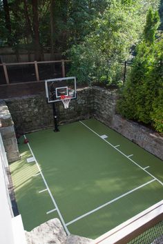 an outdoor basketball court in the backyard