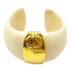 Chanel Super Rare Vintage Gold Plated CC White Stone Cuff Bracelet  *Marked 96 *Made in France *Comes with the original box  -Approximately 2.5″ x 1.5″. -One size fits most. -In a pristine vintage condition.  4916-45375  Please see the measurements section for best approximate dimensions. Collage Outfits, Sticks And Stones, Chanel Vintage, Vintage London, Vintage Bracelet, White Stone, Vintage Chanel, Vintage Bracelets, Vintage Gold