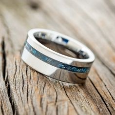 a close up of a wedding ring on a wooden surface