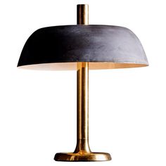 a black and gold lamp on a white background