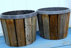 two wooden trash cans sitting on top of a blue floor