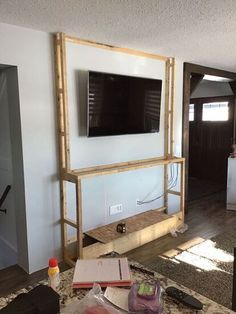 a living room with a flat screen tv mounted to the side of it's wall