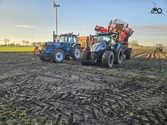 two tractors are parked in the middle of a field