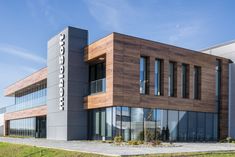 an office building with large windows and wooden facade