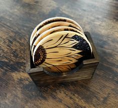 a wooden box filled with lots of different types of plates on top of a table