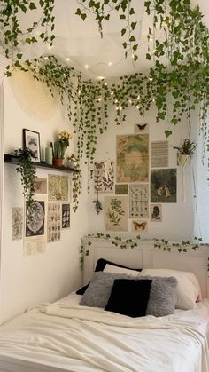 a bed with lots of plants hanging from the ceiling