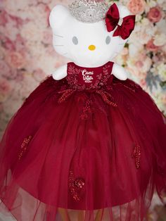 a hello kitty doll wearing a red dress