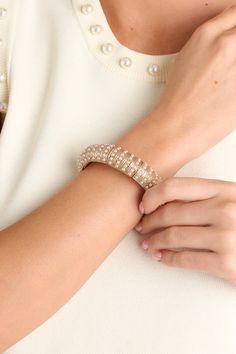 Indulge in sophistication with a touch of fun with our Glowing Sophistication Gold & Ivory Pearl Bracelet. This statement piece features lustrous pearls and a radiant gold finish, adding a touch of glamour to any outfit. Elevate your style with this quirky, must-have accessory. This gold bracelet is adorned with multiple small ivory faux pearls, and elastic bands underneath to accommodate stretch.  Bracelet Measures 2.5" in Diameter Lead Compliant Imported Corporate Chic, Sorority Rush Dresses, Rush Dresses, Cardigan Crop Top, Concert Looks, Ivory Pearl, Long Crop Top, Friend Outfits, Accessories Necklace