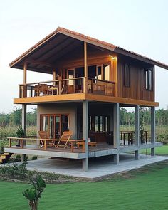 a large wooden house sitting on top of a lush green field