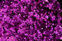 many purple stars are scattered in the air