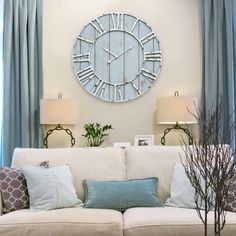 a living room filled with furniture and a large clock on the wall above it's head