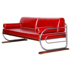 a red leather couch with metal frame and legs