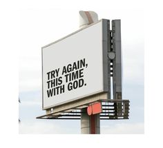 a billboard with the words try again, this time with god on it's side