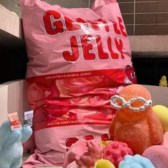 a pile of candy and stuffed animals sitting on top of a table next to a bag of jelly beans