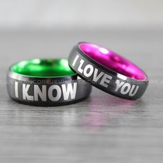 two black and green rings with the words i love you in white lettering on them