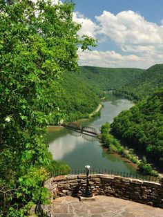 a scenic view of a river surrounded by trees