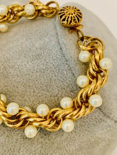 "Vintage gold tone twisted chain link bracelet with faux pearls. The bracelet has a beautiful and unique clasp. It measures 8.5\"." Gold Pearl Bracelet With Chain, Elegant Metal Chain Bracelet With Beaded Chain, Metal Charm Bracelet With Pearl Chain, Elegant Metal Beaded Chain Bracelet, Vintage Gold Pearl Jubilee Bracelet, Vintage Gold Metal Pearl Bracelet, Vintage Gold Pearl Bracelets, Vintage Gold Pearl Bracelet, Green Beaded Bracelets