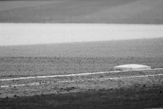 a white object sitting on top of a dirt field