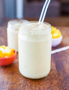 a glass jar filled with yogurt sitting on top of a wooden table