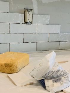 a piece of bread sitting on top of a counter next to some paper towels and glue