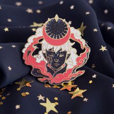 a lapel pin with an image of a demon on it, surrounded by stars