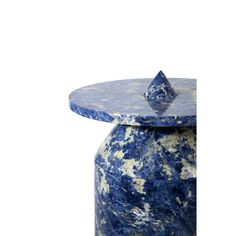 a blue and white vase sitting on top of a table