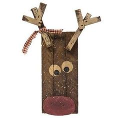 a wooden reindeer head hanging on the side of a wall