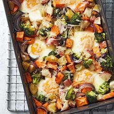 a casserole dish with broccoli, carrots, onions and cheese