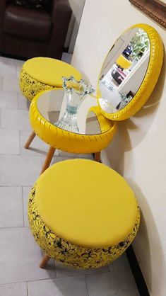 two yellow stools with mirrors on them