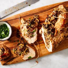 some meat is laying on a wooden cutting board