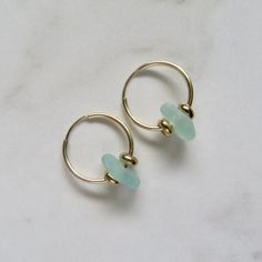 Seaglass Hoop Earrings~ These cute small endless hoops have light blue/green seaglass and gold beads, great gift for the beach lover. Hoops 16mm. *This listing is for the earrings in the first photo ready to ship **video shows 20 and 24mm. hoops Shop~ http://www.etsy.com/shop/HanaMauiCreations?ref=pr_shop_more International buyers please read our shipping policies before ordering~ POLICIES~ https://www.etsy.com/shop/HanaMauiCreations/policy?ref=shopinfo_policies_leftnav Dainty Green Jewelry For Beach, Green Hoop Earrings For The Beach, Green Hoop Earrings For Beach, Handmade 14k Gold Filled Beach Earrings, Handmade 14k Gold Filled Earrings For Beach, Handmade 14k Gold-filled Earrings For Beach, Minimalist Beach Jewelry With Ear Wire, Minimalist Handmade Earrings For Beach, Glass Hoop Earrings For Gift