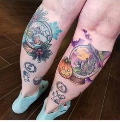 two people with tattoos on their legs, one has a snow globe and the other has pumpkins